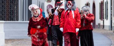 Carnival characters walking the old town of Basel during carnival